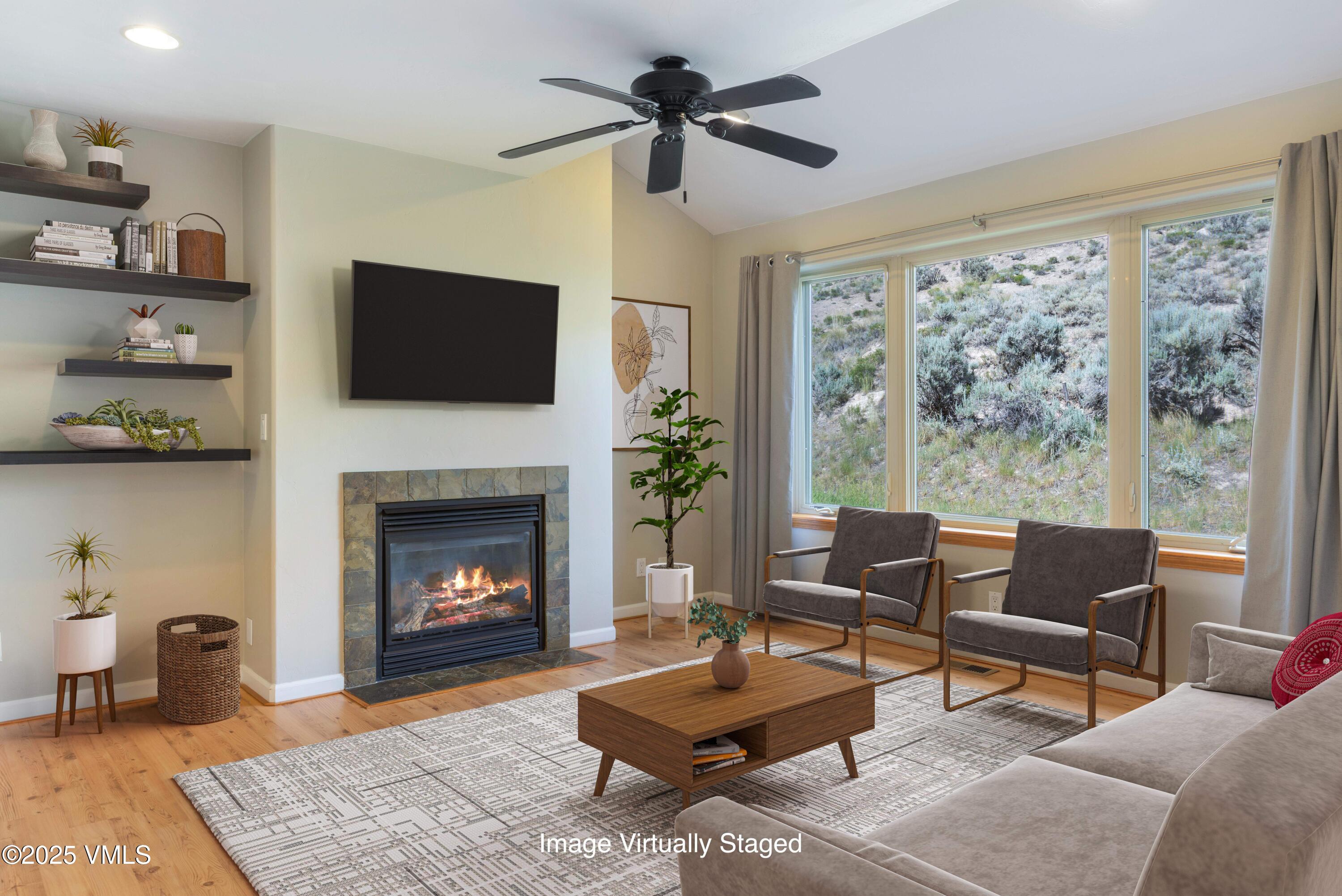 60 Mill Road, Unit J1 Eagle, CO 81631 - Photo 4 of 31 a living room with furniture a flat screen tv and a fireplace
