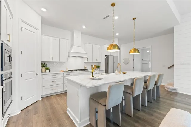 a living room with furniture and a dining table with kitchen view