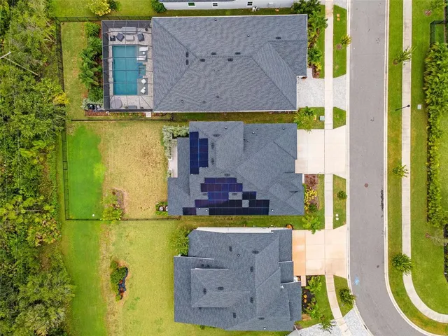 an aerial view of a house with garden space and street view