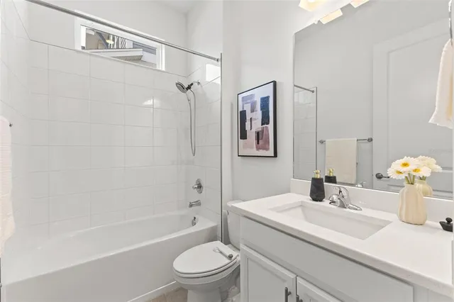 a spacious bedroom with a bed and a flat screen tv