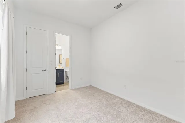 a view of an empty room with closet
