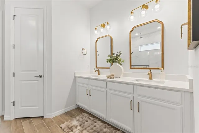 a view of empty room with wooden floor and entryway