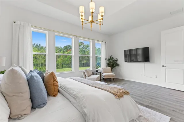 an aerial view of residential houses with outdoor space and ocean view