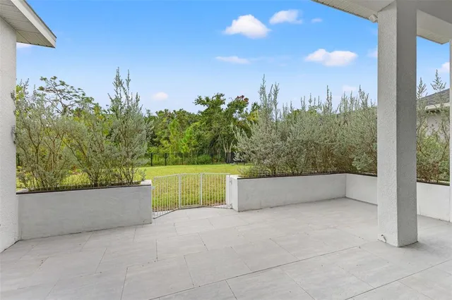 an aerial view of a balcony with chairs