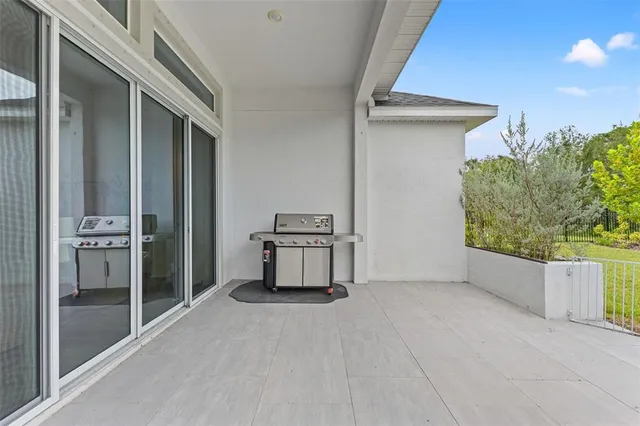 an aerial view of residential houses with outdoor space and ocean view