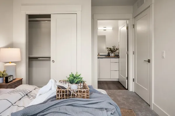 a bedroom with a bed and a potted plant