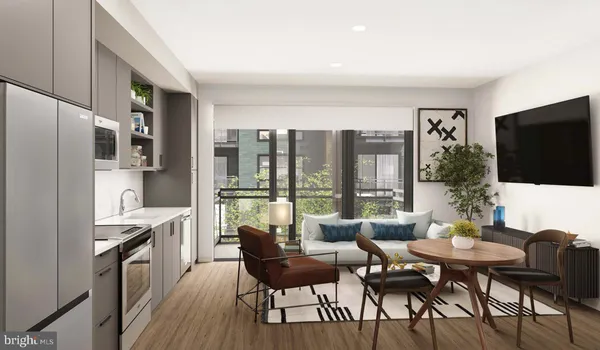 a view of a kitchen with a stove top oven a refrigerator and wooden floor