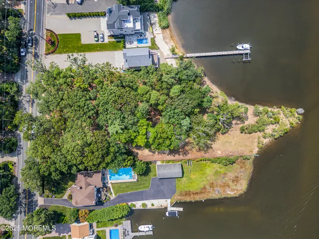 an aerial view of a house with a garden and lake view
