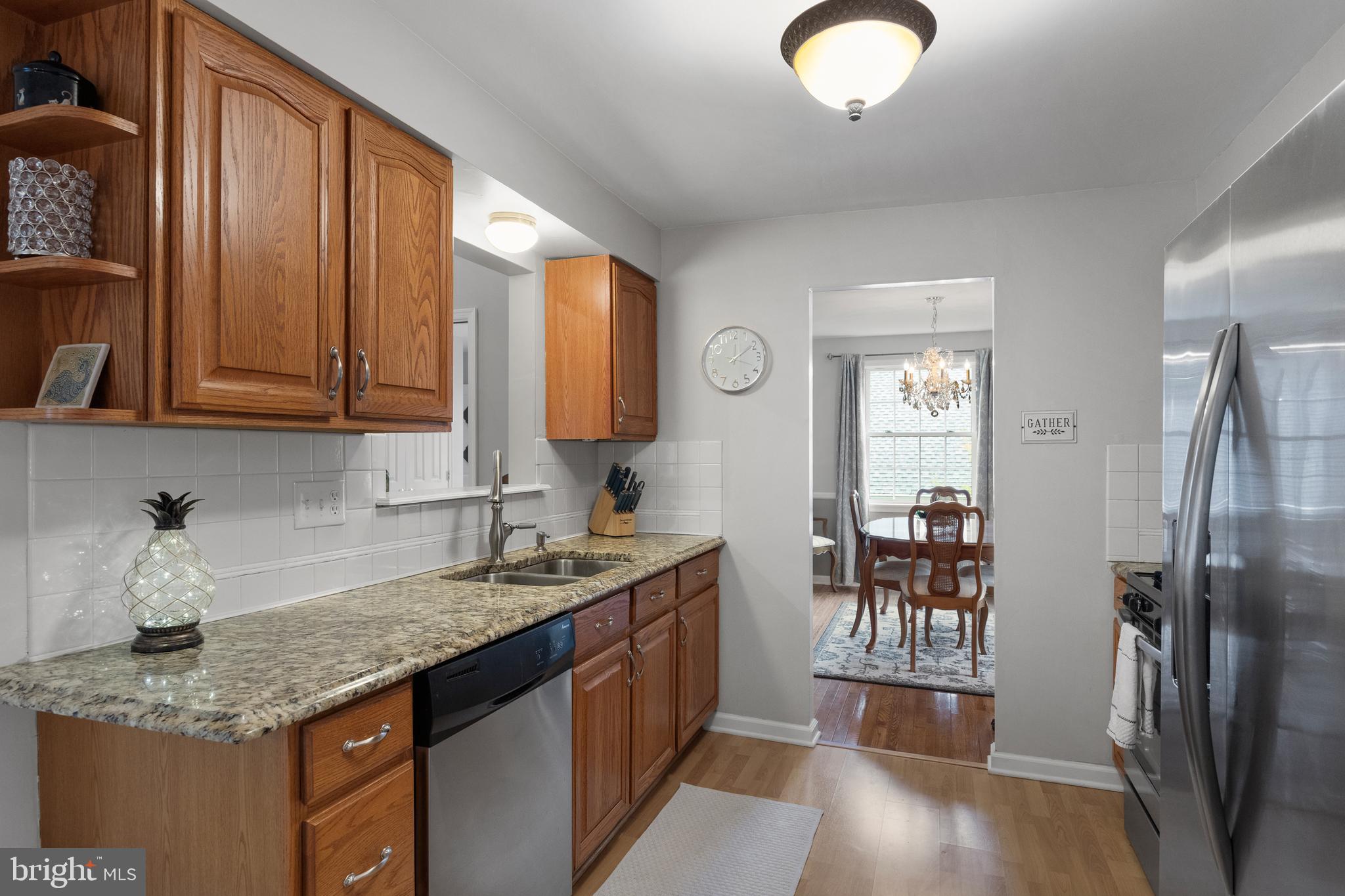 179 Forge Road Delran, NJ 08075 - Photo 12 of 35 a kitchen with stainless steel appliances granite countertop a sink dishwasher stove and cabinets with wooden floor