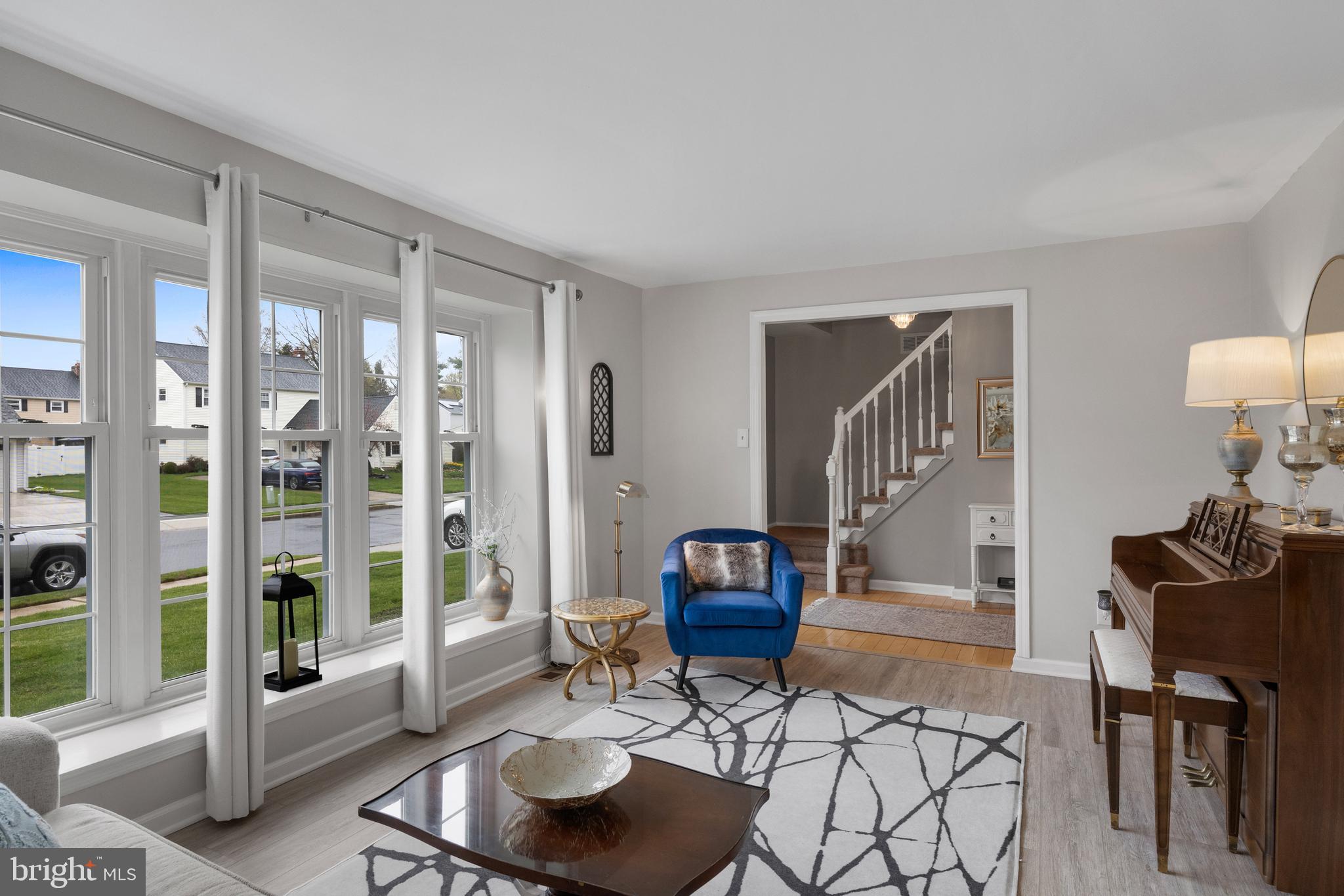 179 Forge Road Delran, NJ 08075 - Photo 8 of 35 a living room with furniture a rug and a floor to ceiling window