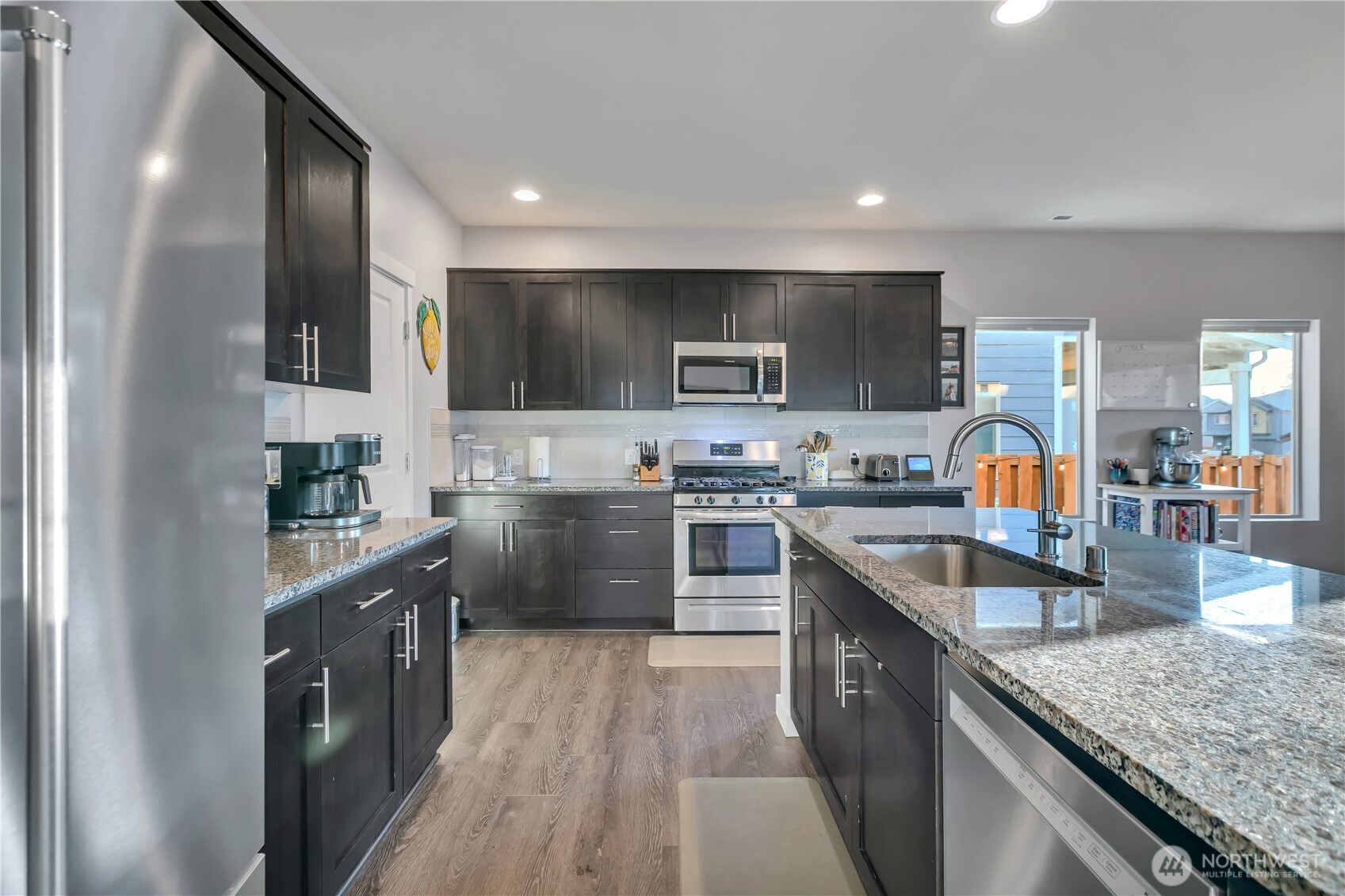 291 South Sergeant Street Buckley, WA 98321 - Photo 12 of 38 a kitchen with stainless steel appliances granite countertop sink stove refrigerator and cabinets