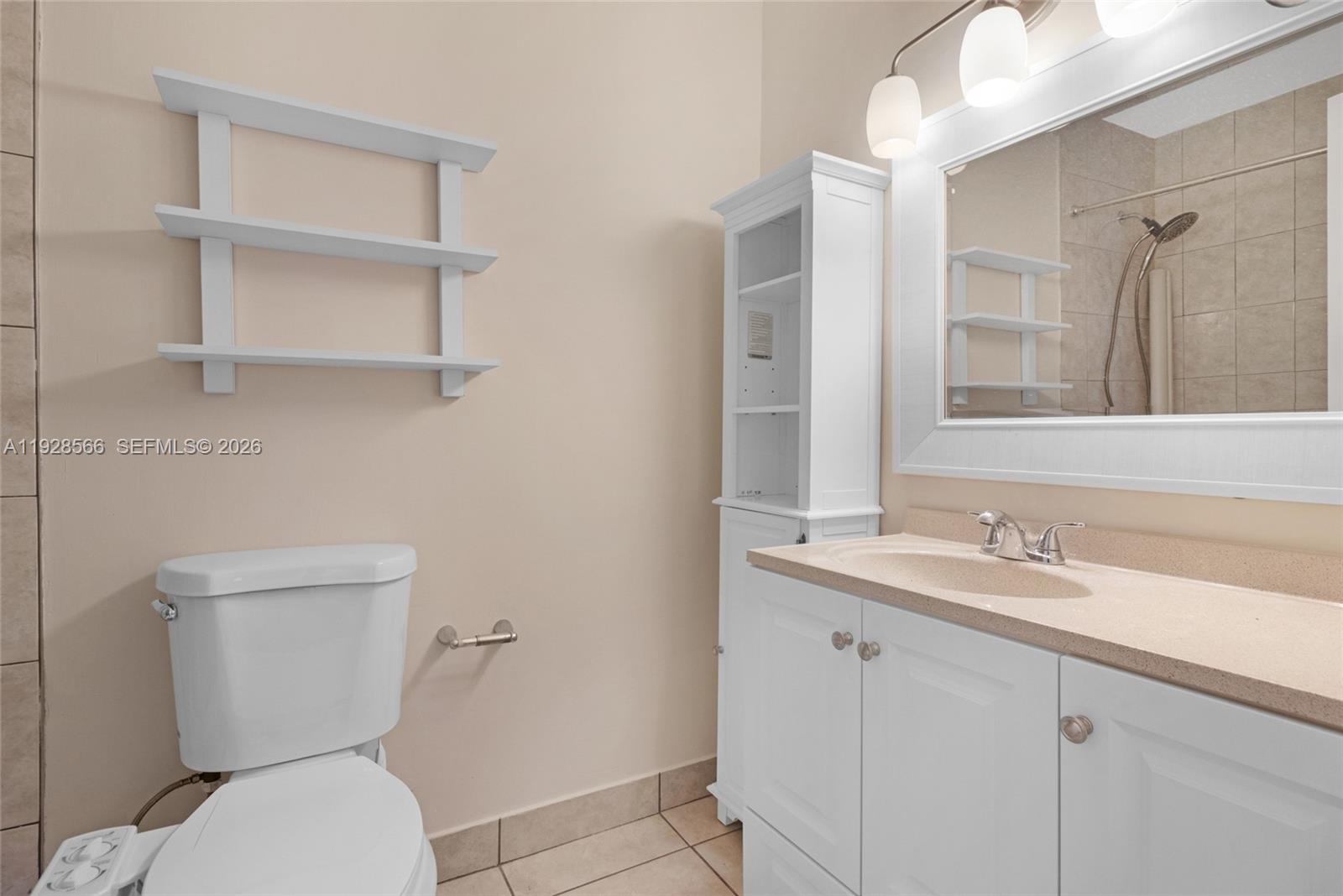 4714 Southwest 67th Avenue, Unit C1 Miami, FL 33155 - Photo 22 of 37 a bathroom with a toilet sink and mirror