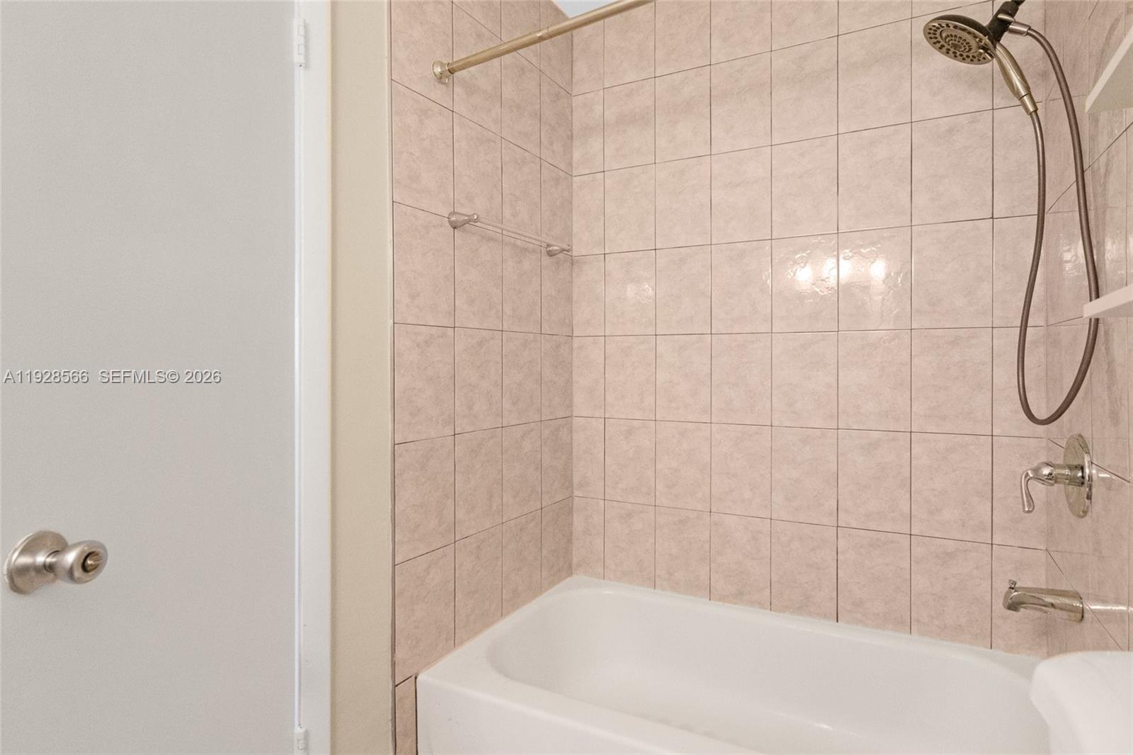 4714 Southwest 67th Avenue, Unit C1 Miami, FL 33155 - Photo 23 of 37 a bathroom with a white bath tub
