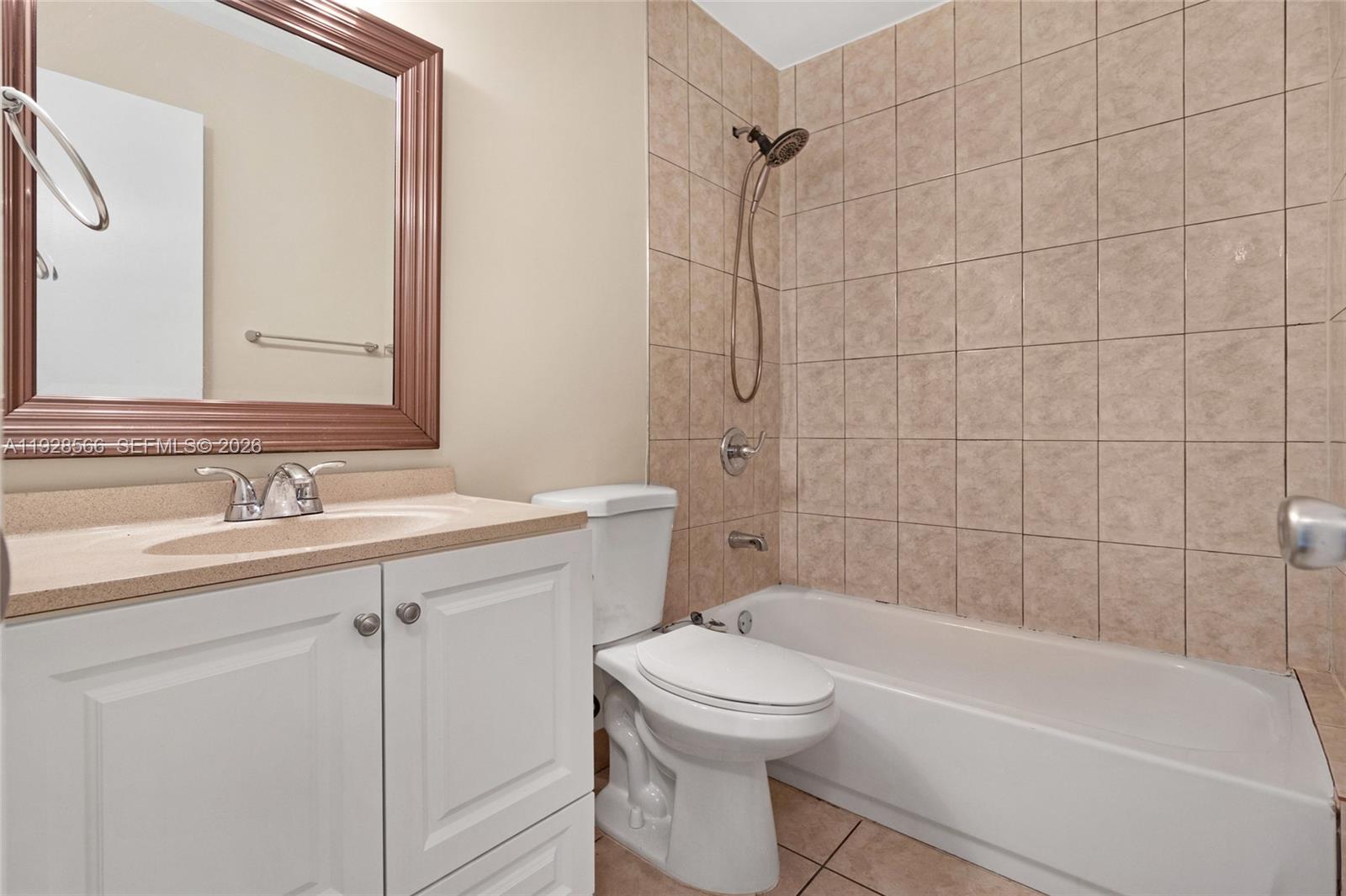 4714 Southwest 67th Avenue, Unit C1 Miami, FL 33155 - Photo 31 of 37 a bathroom with a sink a toilet and shower