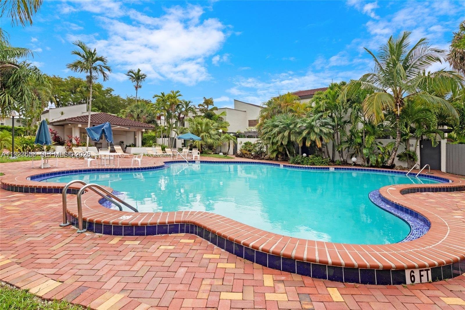 4714 Southwest 67th Avenue, Unit C1 Miami, FL 33155 - Photo 35 of 37 a view of a swimming pool with a patio