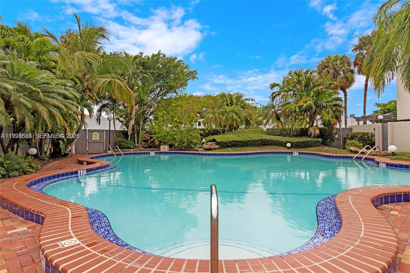 4714 Southwest 67th Avenue, Unit C1 Miami, FL 33155 - Photo 36 of 37 a view of a swimming pool with a patio