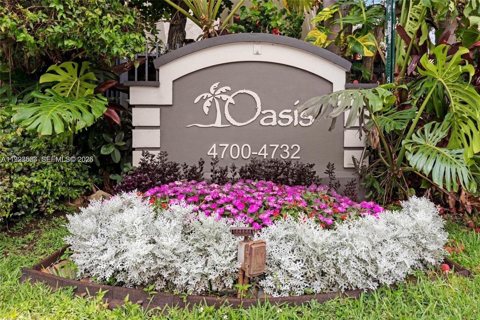 4714 Southwest 67th Avenue, Unit C1 Miami, FL 33155 - Photo 37 of 37 a view of sign board with flower plants