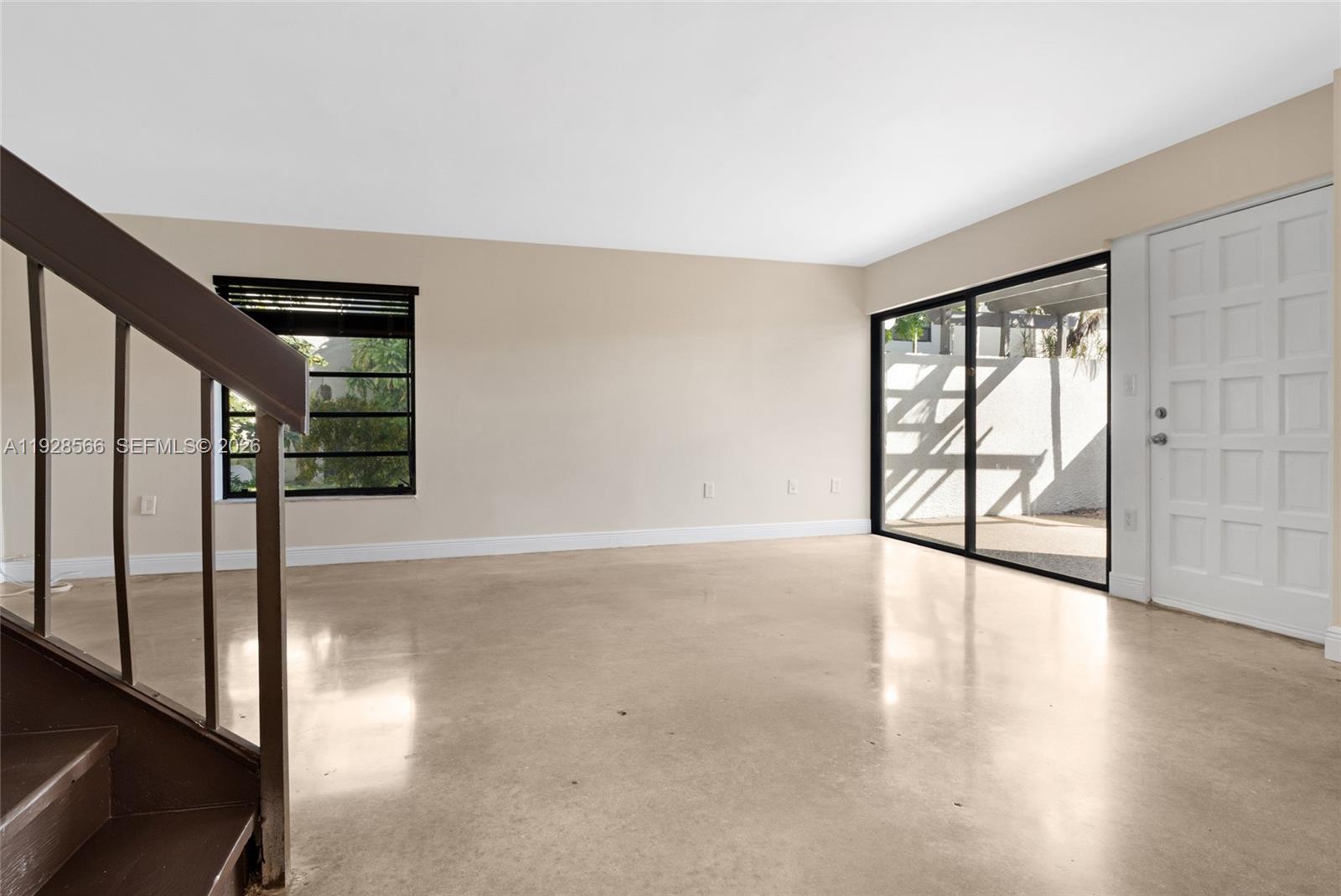 4714 Southwest 67th Avenue, Unit C1 Miami, FL 33155 - Photo 5 of 37 wooden floor in an empty room with a window