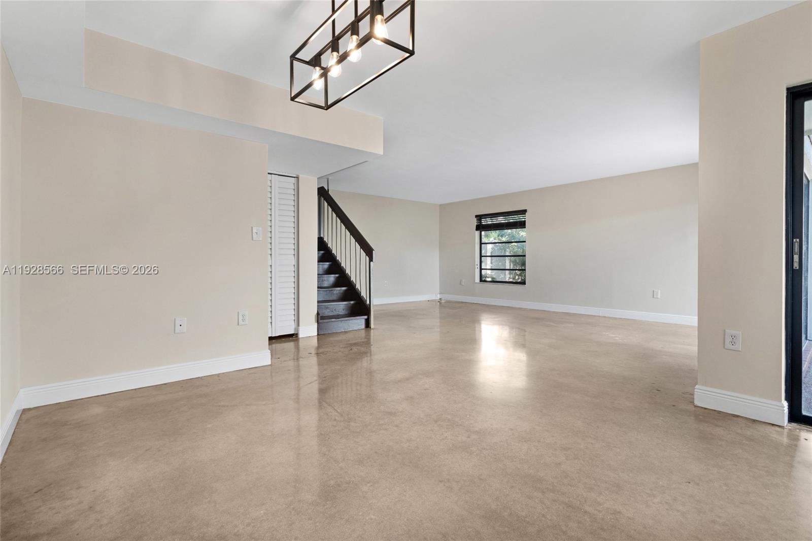 4714 Southwest 67th Avenue, Unit C1 Miami, FL 33155 - Photo 8 of 37 an empty room with windows and entryway
