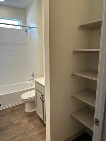 a bathroom with a toilet and a shower