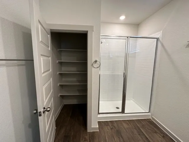 a view of walk in closet with empty racks