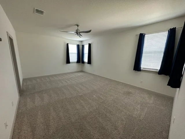 en empty room with windows and closet