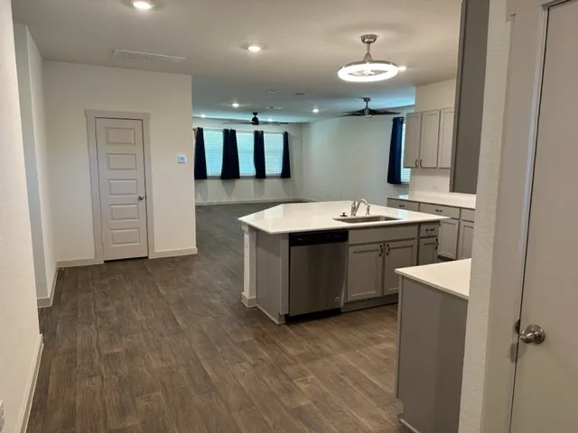 a kitchen with a sink and a refrigerator
