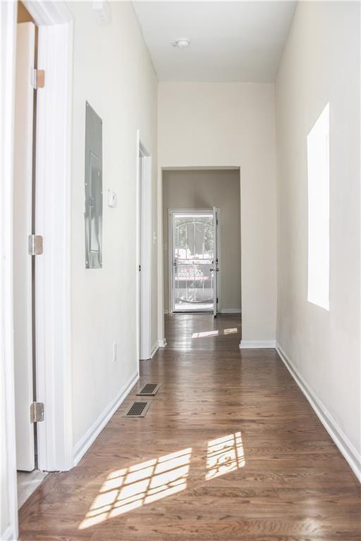 911 Smith Street Southwest Atlanta, GA 30310 - Photo 9 of 13 a view of a hallway with wooden floor and a living room