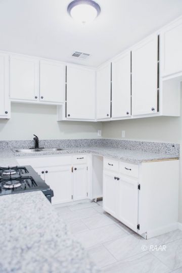 204 North Florence Street Ridgecrest, CA 93555 - Photo 12 of 27 a kitchen with granite countertop white cabinets and white appliances
