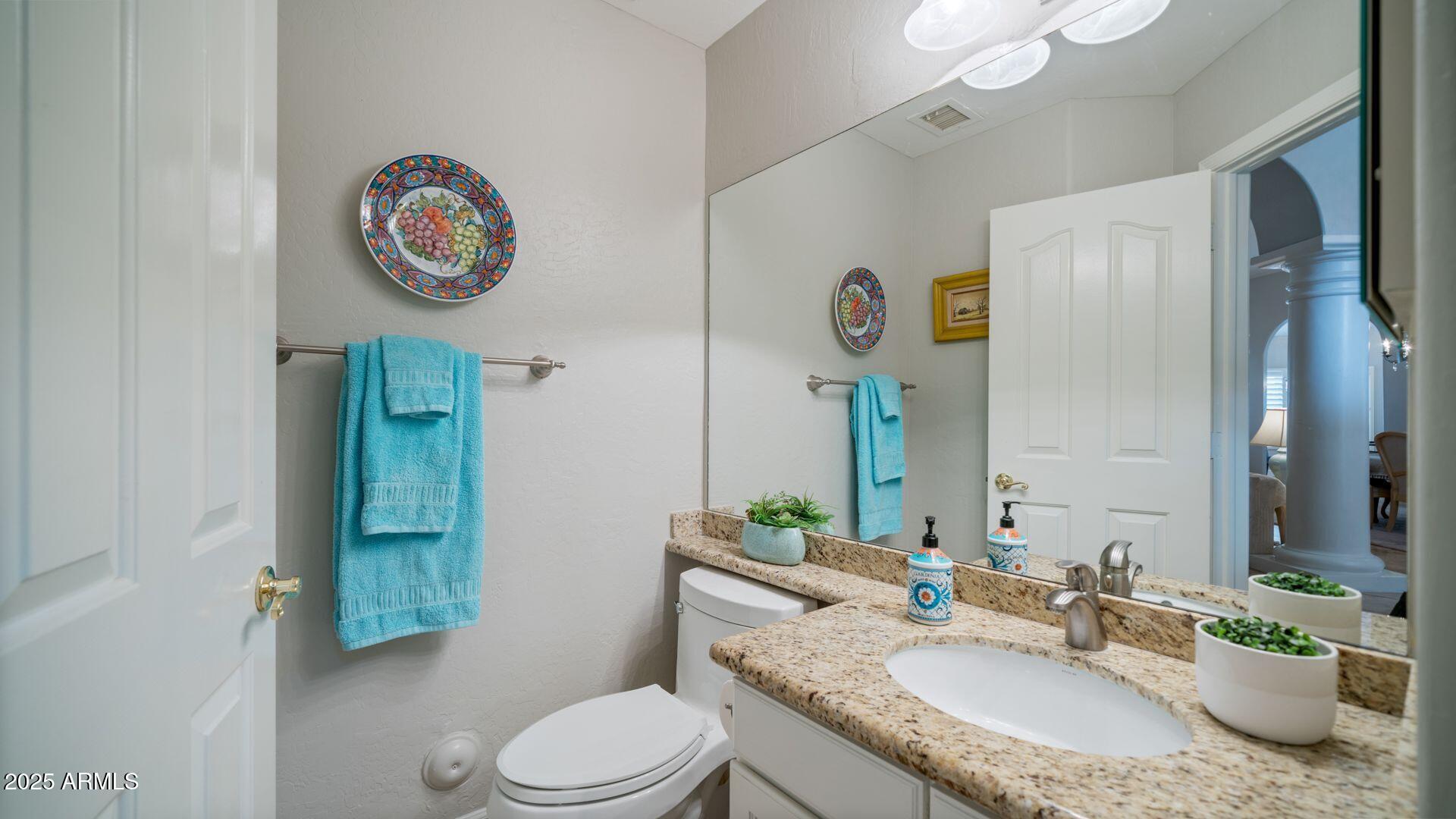 2214 East Beachcomber Drive Gilbert, AZ 85234 - Photo 13 of 45 a bathroom with a granite countertop sink and a mirror