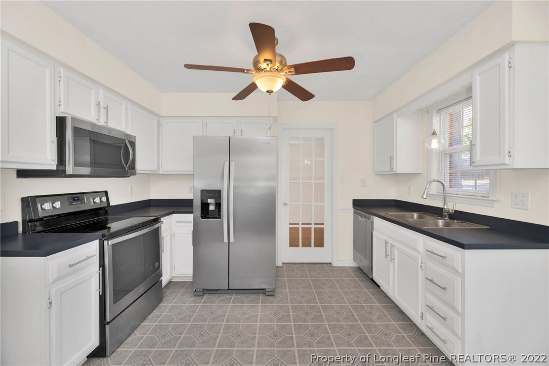 365 Sawyer Road Cameron, NC 28326 - Photo 12 of 37 a kitchen with a sink appliances and cabinets