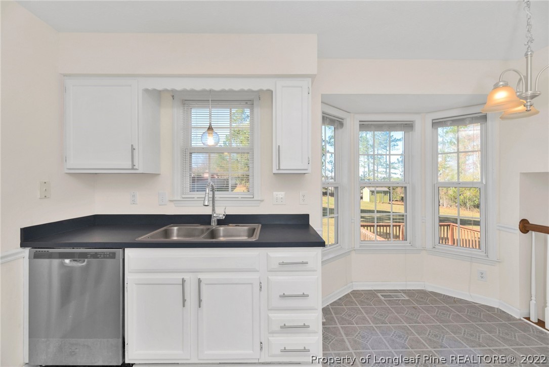365 Sawyer Road Cameron, NC 28326 - Photo 13 of 37 a kitchen with granite countertop white cabinets and window