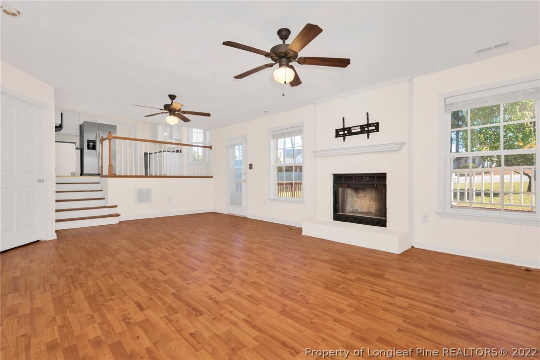 365 Sawyer Road Cameron, NC 28326 - Photo 19 of 37 a view of empty room with wooden floor and fireplace
