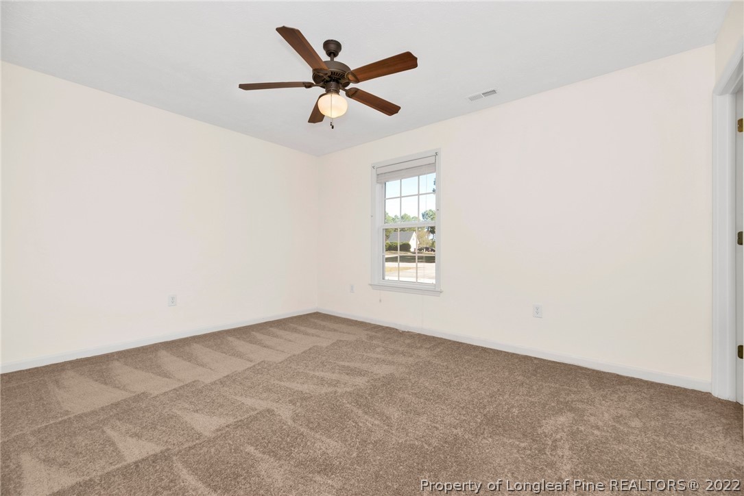 365 Sawyer Road Cameron, NC 28326 - Photo 20 of 37 an empty room with ceiling fan and windows