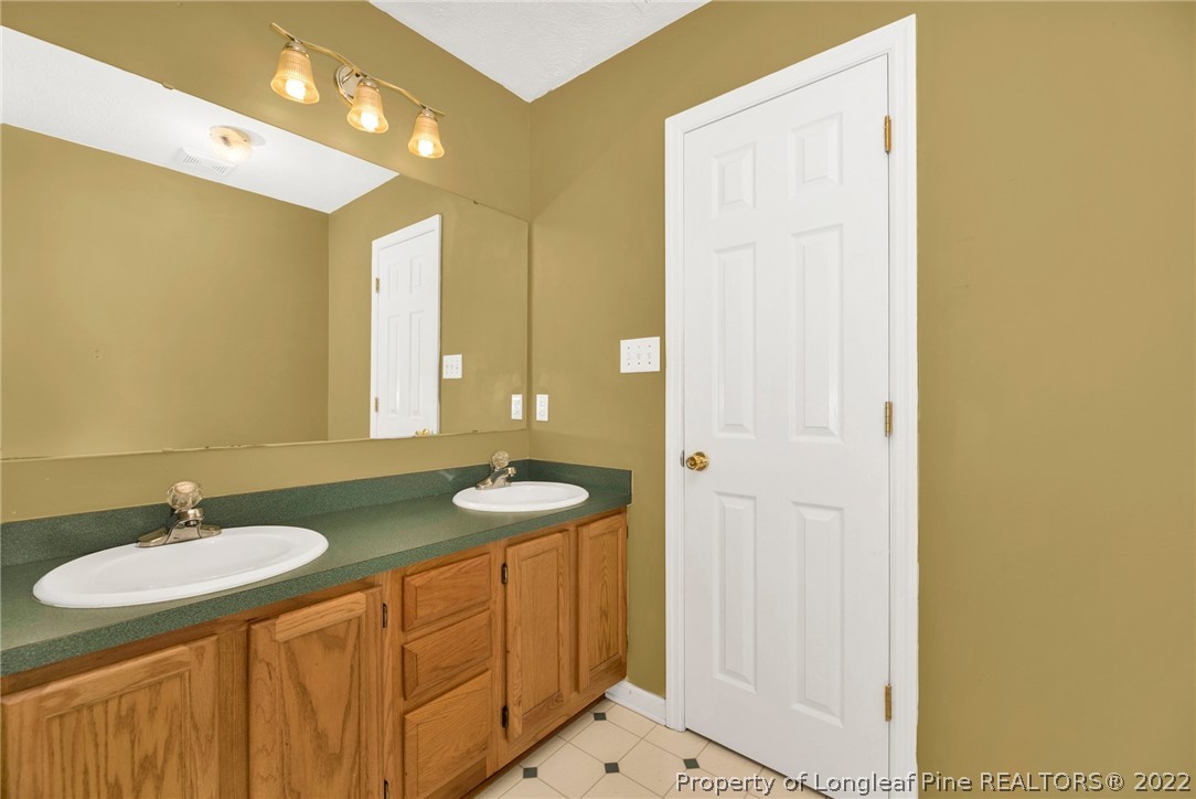 365 Sawyer Road Cameron, NC 28326 - Photo 31 of 37 a bathroom with 2 sink and a mirror