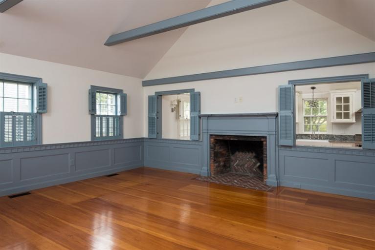154 Shore Road Chatham, MA 02633 - Photo 8 of 14 a living room with a fireplace and a window