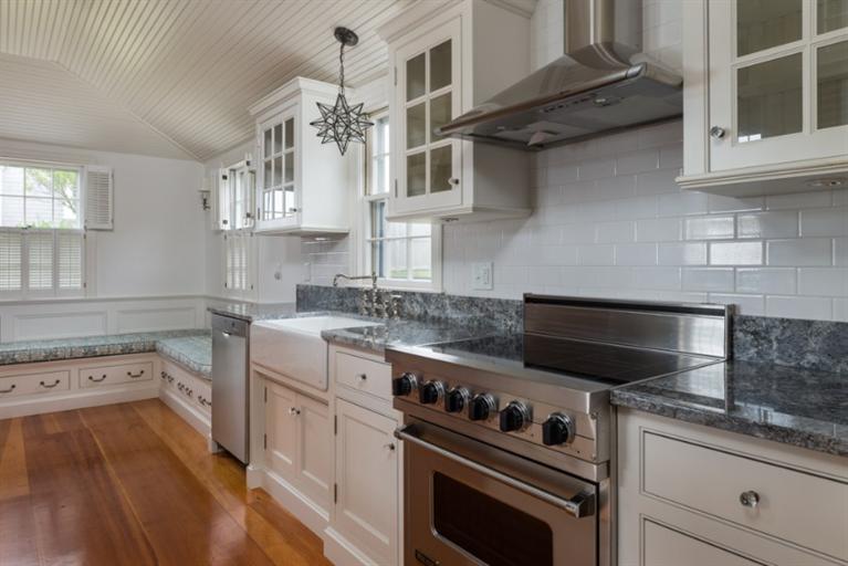 154 Shore Road Chatham, MA 02633 - Photo 10 of 14 a kitchen with a stove and white cabinets