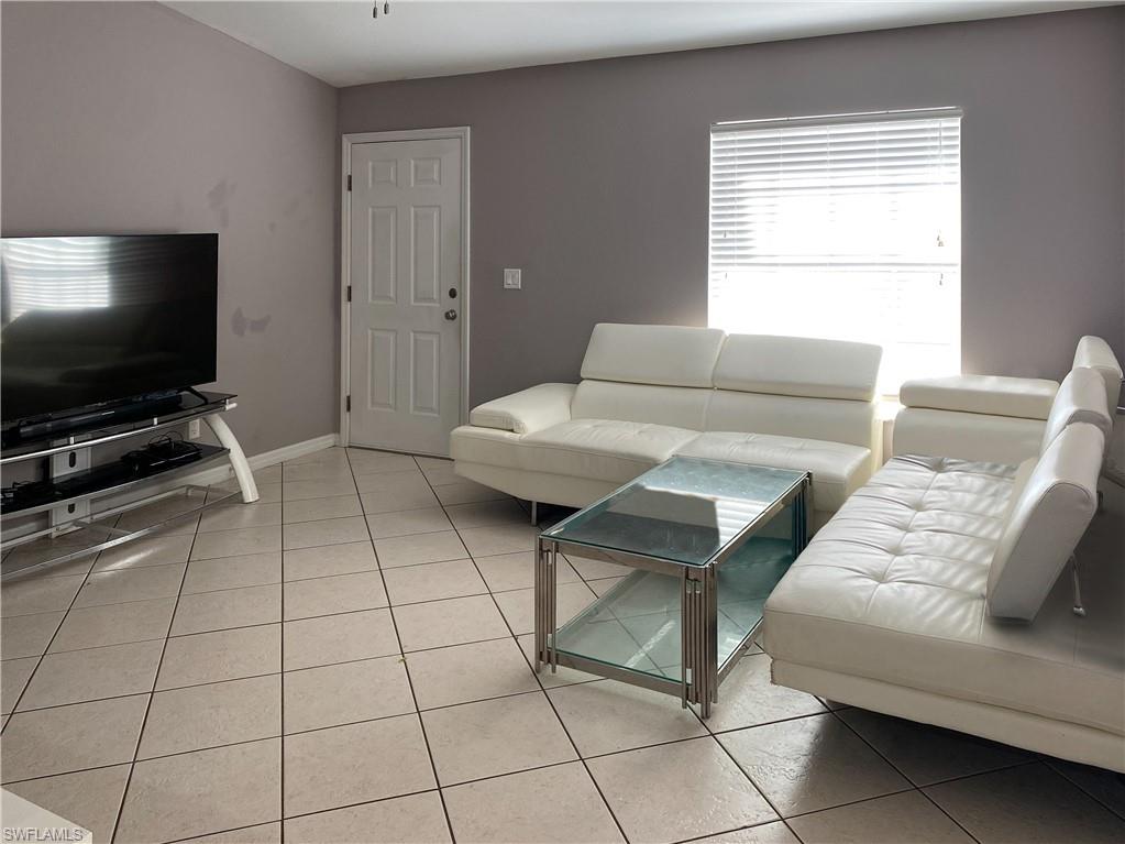 8133 Egret Road Fort Myers, FL 33967 - Photo 2 of 4 a living room with furniture and a flat screen tv