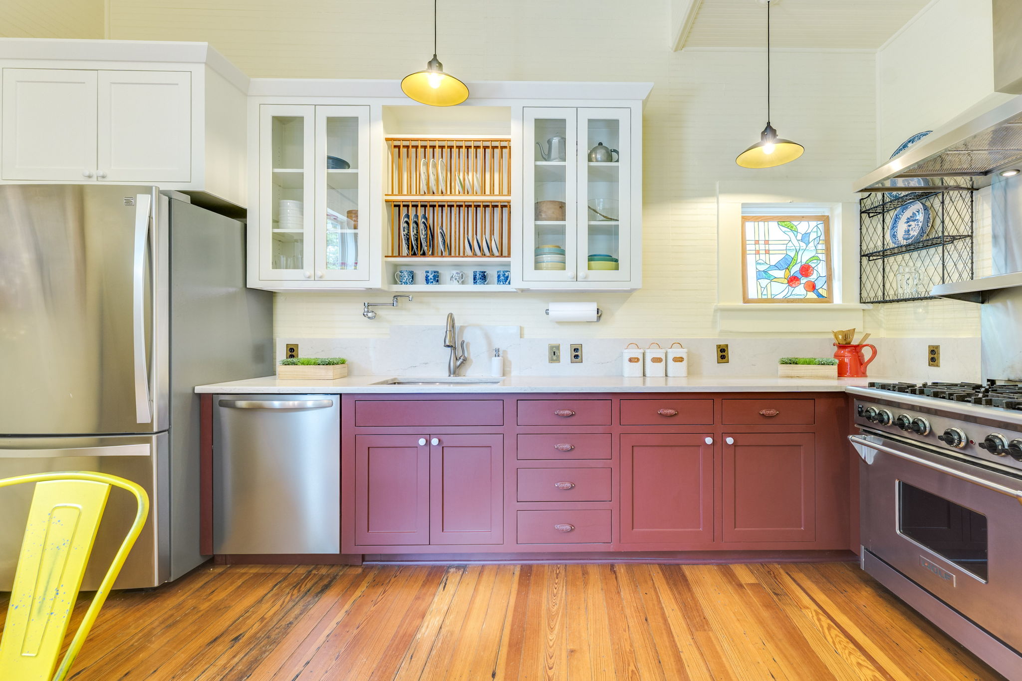 3908 Avenue D Austin, TX 78751 - Photo 11 of 26 a kitchen with granite countertop wooden cabinets stainless steel appliances and a window