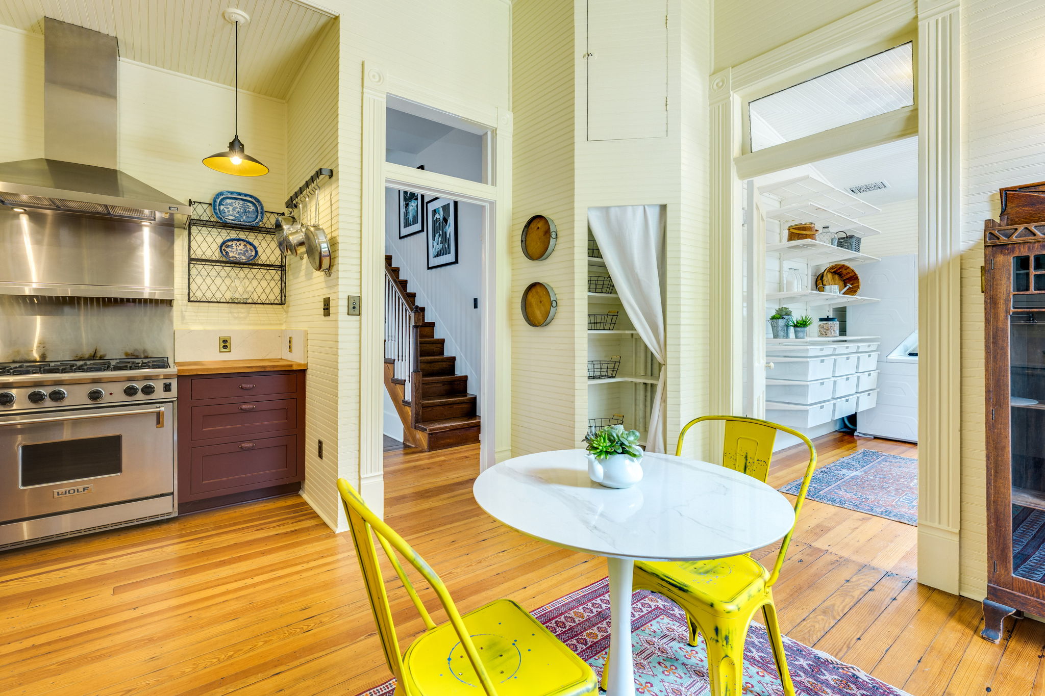 3908 Avenue D Austin, TX 78751 - Photo 15 of 26 a kitchen with stainless steel appliances kitchen island granite countertop a sink a stove a dining table and chairs