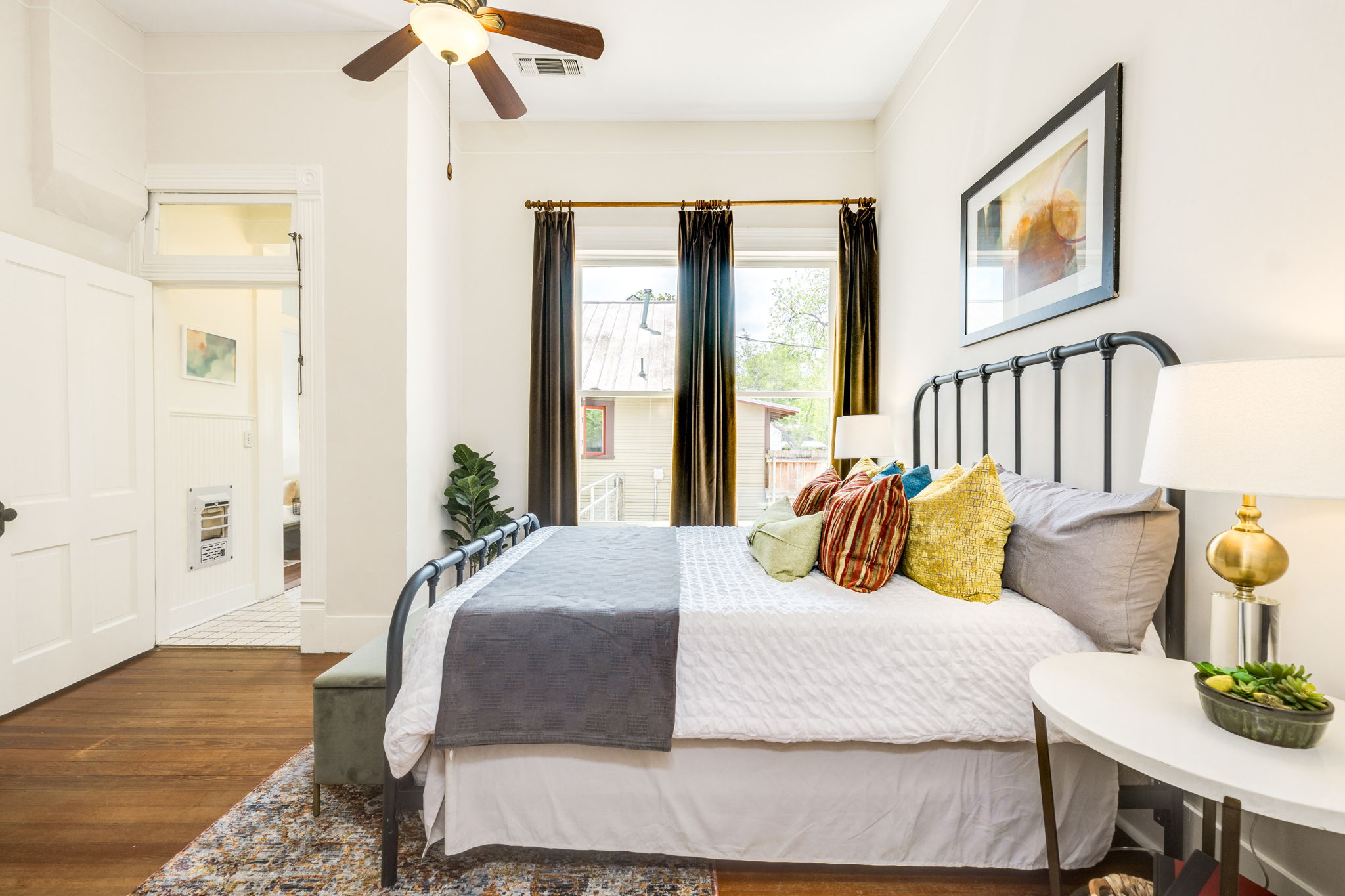 3908 Avenue D Austin, TX 78751 - Photo 17 of 26 a bedroom with a bed and wooden floor