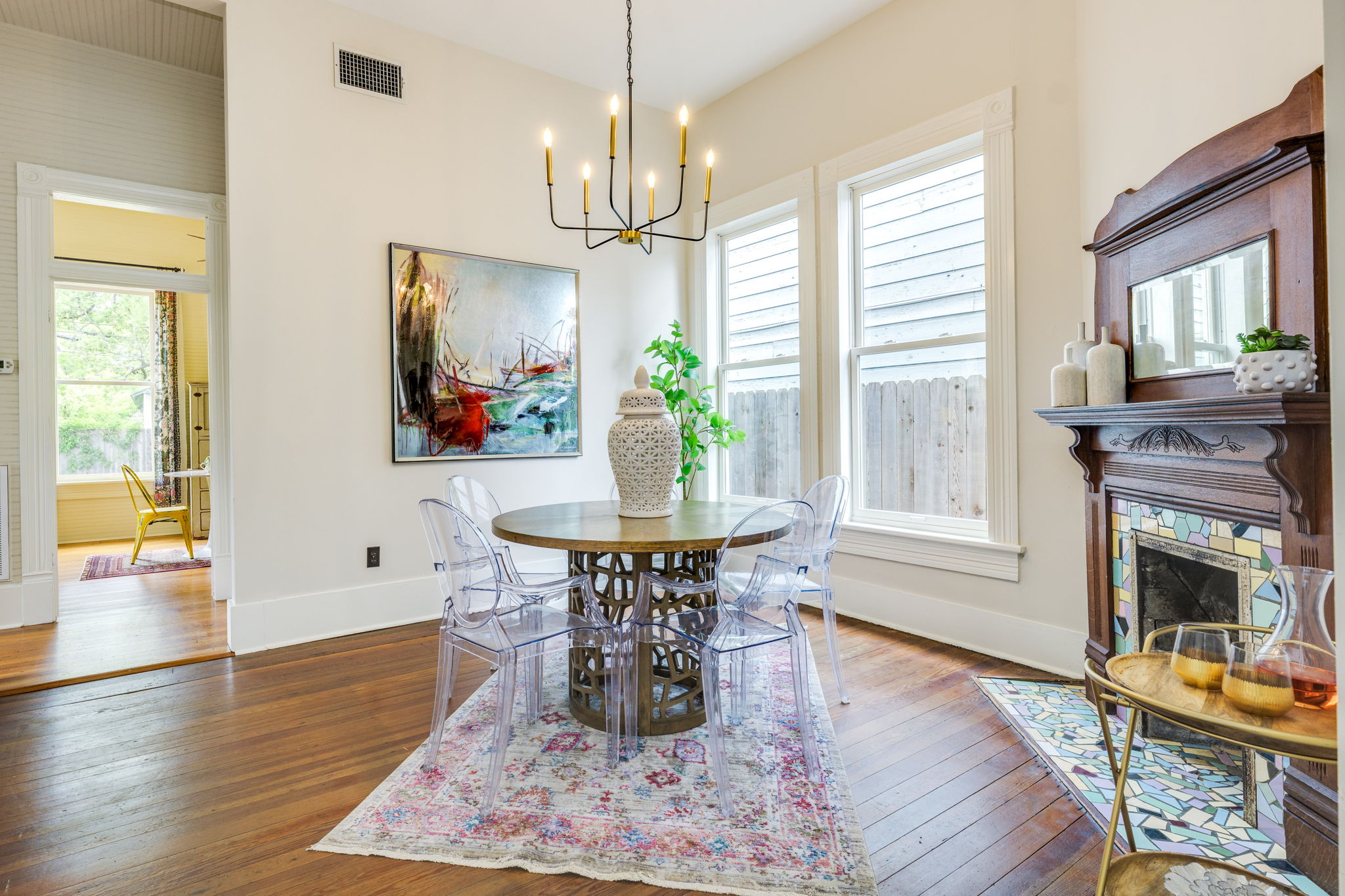 3908 Avenue D Austin, TX 78751 - Photo 8 of 26 a dining room with wooden floor a chandelier a wooden table and chairs