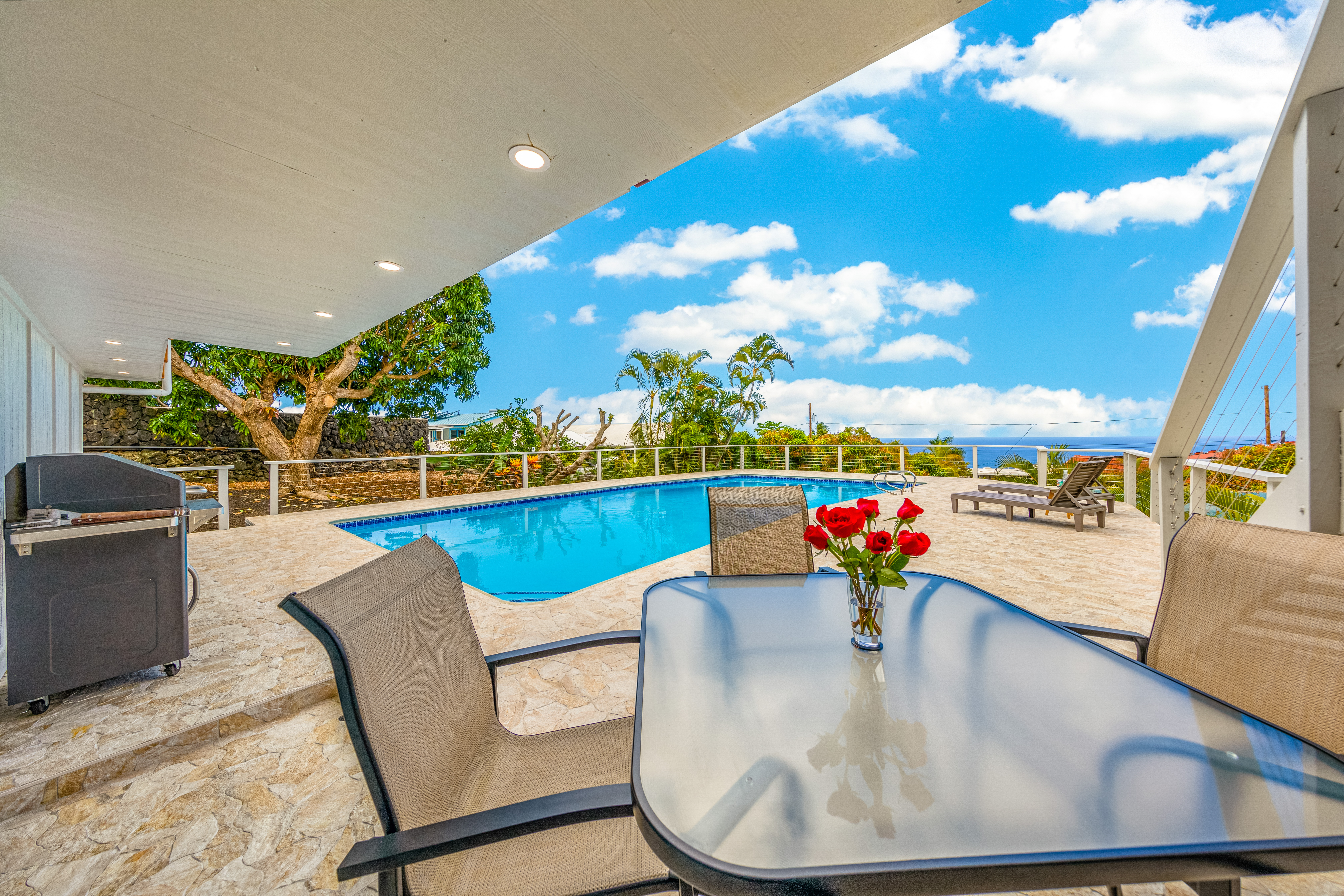 77-6472 Kilohana Street Kailua-Kona, HI 96740 - Photo 16 of 29 a view of a dining room with furniture a chandelier and wooden floor