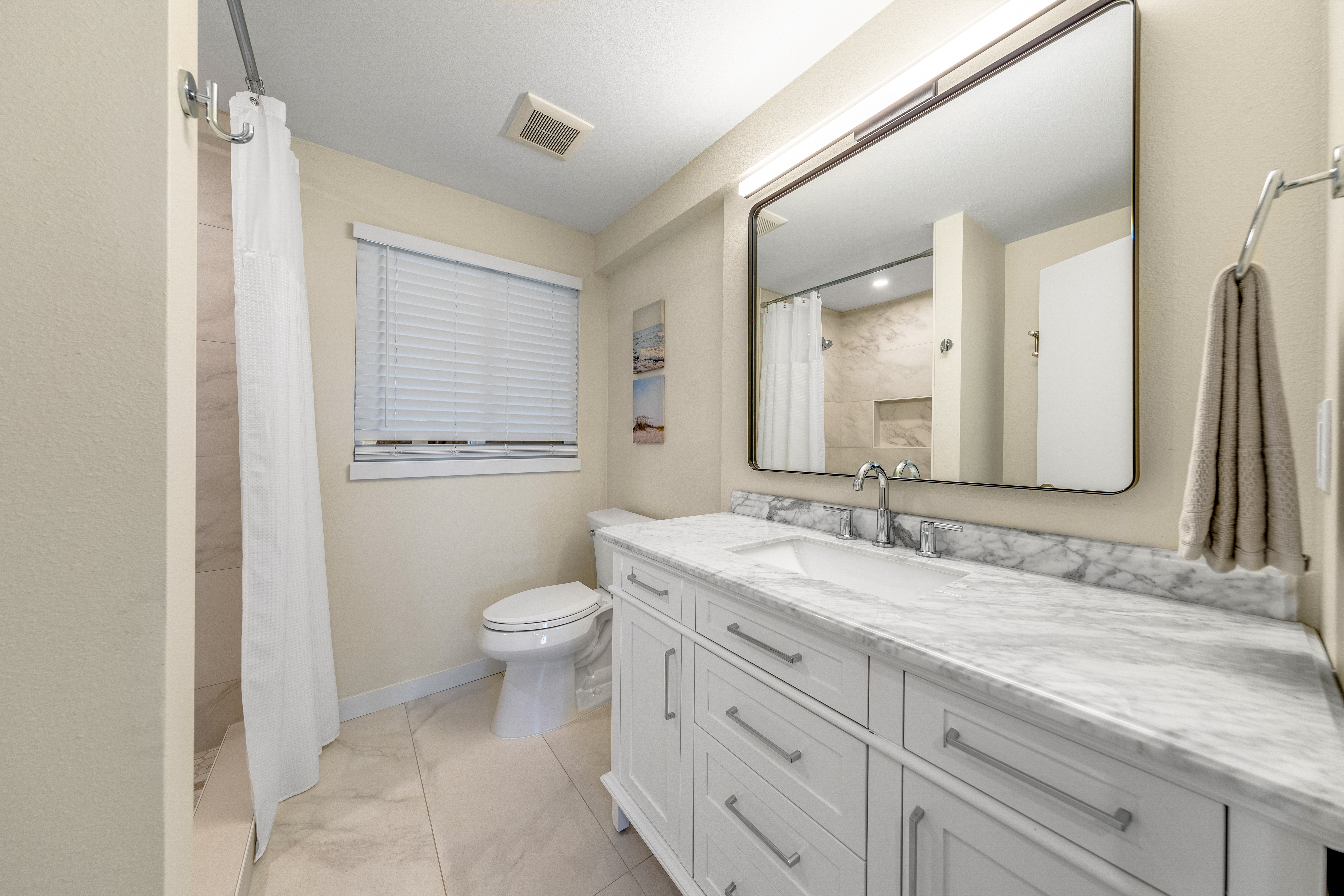77-6472 Kilohana Street Kailua-Kona, HI 96740 - Photo 22 of 29 a bathroom with a granite countertop toilet sink and a mirror