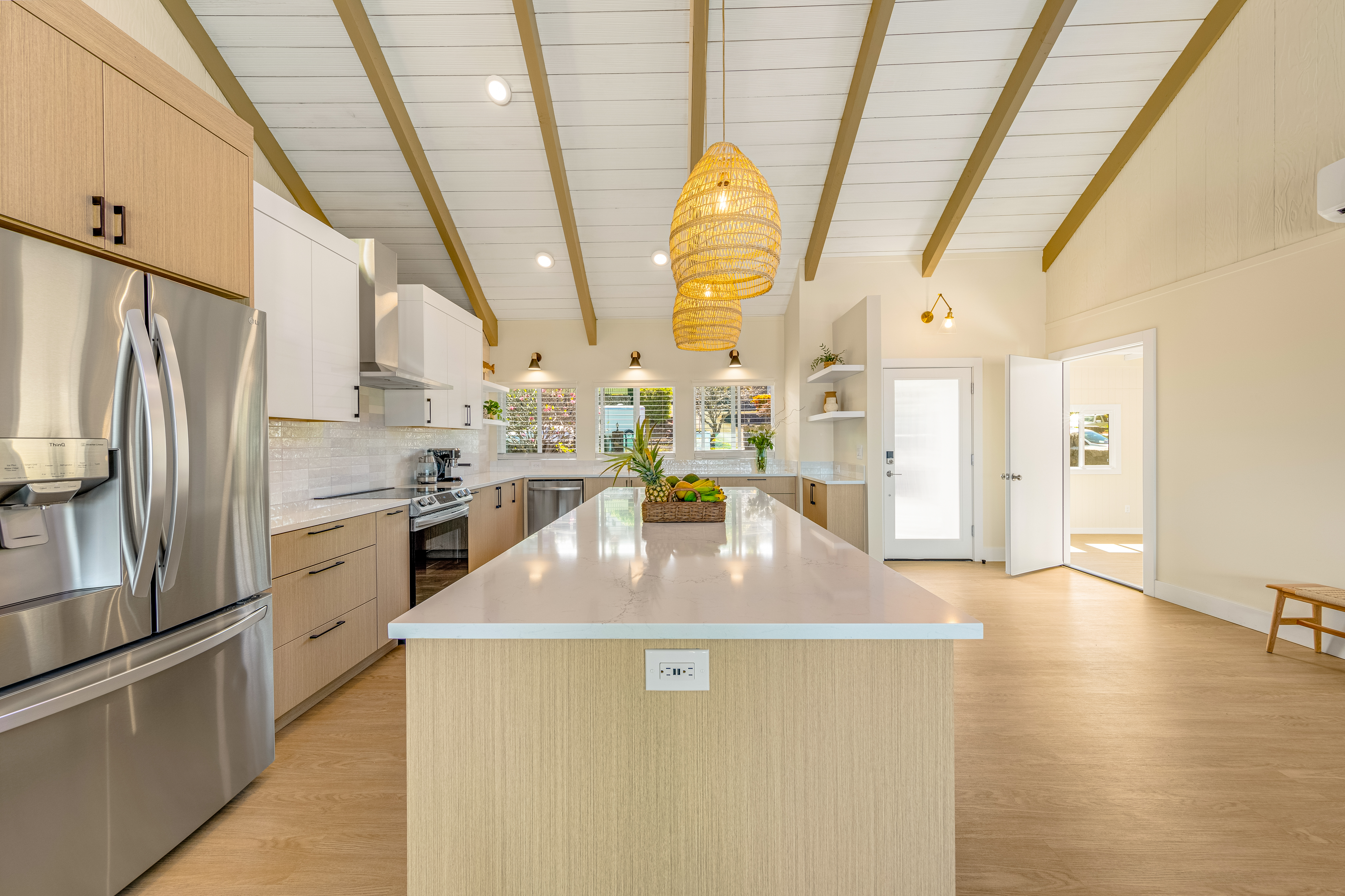 77-6472 Kilohana Street Kailua-Kona, HI 96740 - Photo 28 of 29 a kitchen with stainless steel appliances a refrigerator a sink a stove and white cabinets with wooden floor