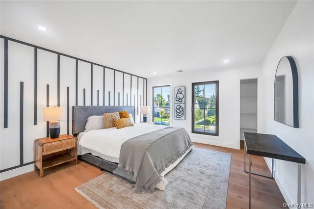 a bedroom with a large bed and a window