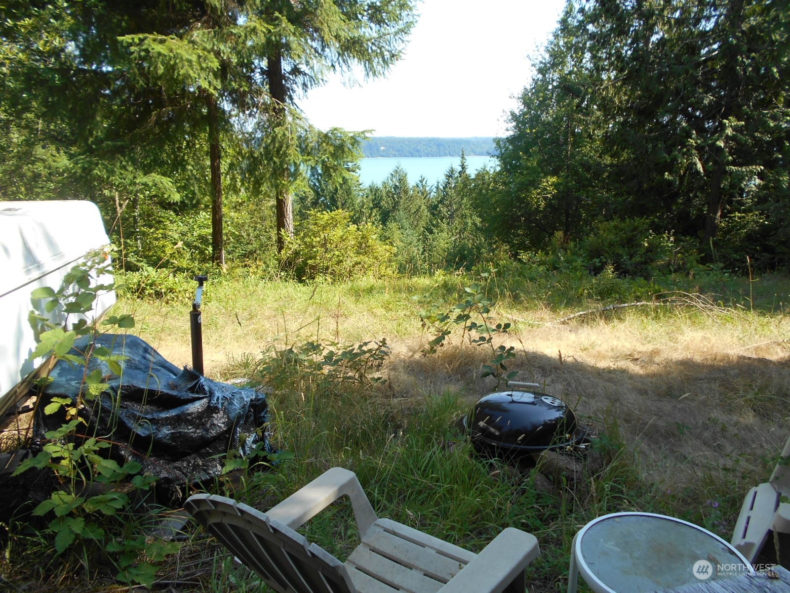 0 Yashi Road Brinnon, WA 98320 - Photo 32 of 38 a backyard of a house with yard table and chairs