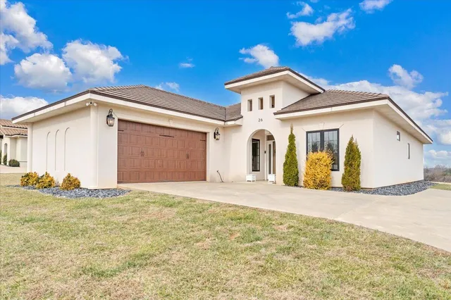 a view of a house with a yard and garage