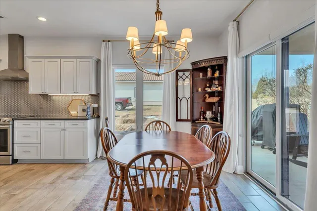a kitchen with granite countertop kitchen island stainless steel appliances a sink and cabinets