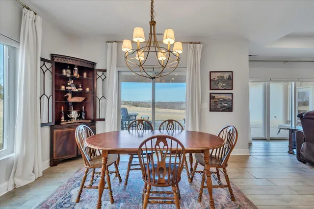 a white kitchen with stainless steel appliances granite countertop a stove a sink dishwasher and a refrigerator